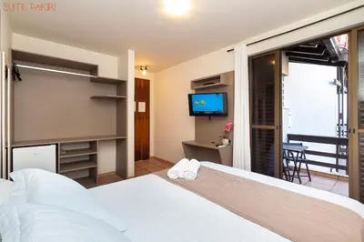 Uma cama ou camas num quarto em Pousada Kia Ora Bombinhas