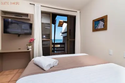 Uma cama ou camas num quarto em Pousada Kia Ora Bombinhas