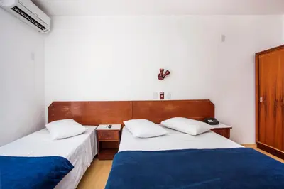 Uma cama ou camas num quarto em Hotel Itapema Meia Praia