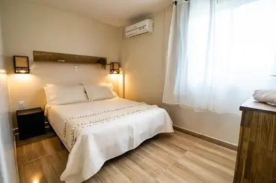 Uma cama ou camas num quarto em Hospedagem Morada Nativa Praia Bombas