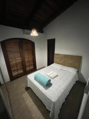 Uma cama ou camas num quarto em Casa Marrom