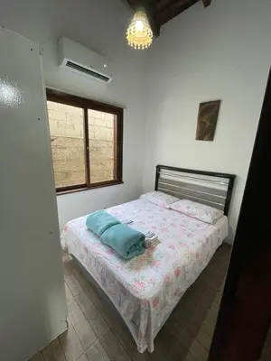 Uma cama ou camas num quarto em Casa Marrom