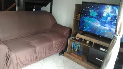 Uma televisão e/ou sistema de entretenimento em Apartamento Bay Conceicao