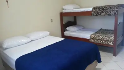 Uma cama ou camas num quarto em Casas na Praia de Bombas - Bombinhas