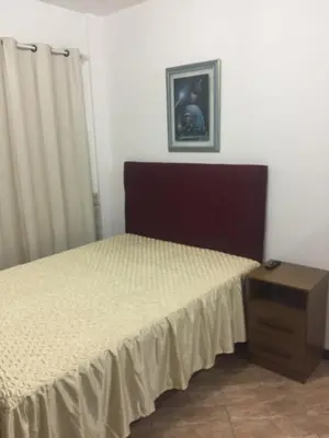 Uma cama ou camas num quarto em Pousada Alessandra