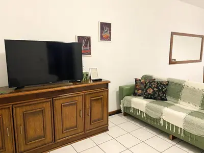 Uma televisão e/ou sistema de entretenimento em Apartamento - Pé na Areia