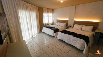 Uma cama ou camas num quarto em Hotel Gênova BC