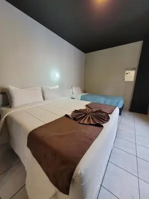 Uma cama ou camas num quarto em Hotel Gênova BC