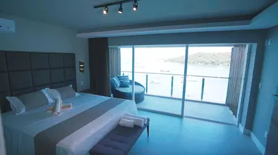 Uma cama ou camas num quarto em Caixa D'aço Exclusive Hotel