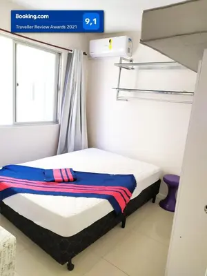 Uma cama ou camas num quarto em Lindo apartamento Avenida Brasil