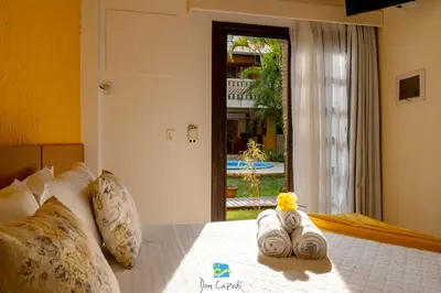 Uma cama ou camas num quarto em Pousada Dom Capudi