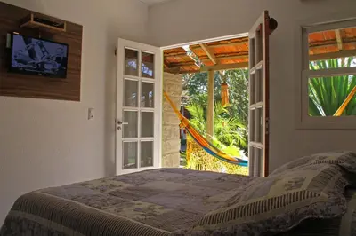 Uma cama ou camas num quarto em Pousada Estaleiro Village - Frente Mar
