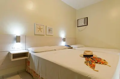 Uma cama ou camas num quarto em Pousada Villa Atlântica