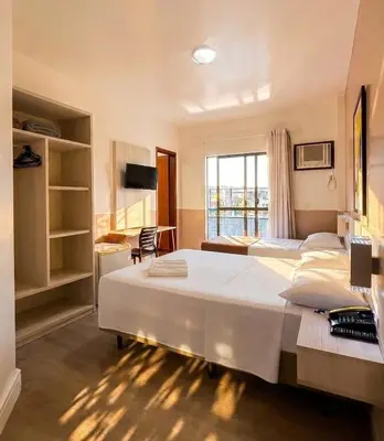 Uma cama ou camas num quarto em Pousada Villa Atlântica