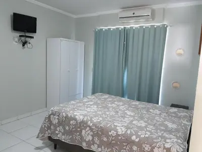 Uma cama ou camas num quarto em Carpe Diem Bombinhas