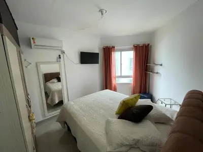 Uma cama ou camas num quarto em Itapema-Meia Praia- quartos -Frente Mar!