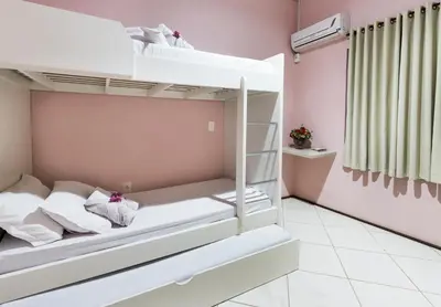 Uma cama ou camas num quarto em Pousada Vila Taquaras