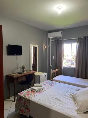 Uma cama ou camas num quarto em Pousada Vovo Valdir