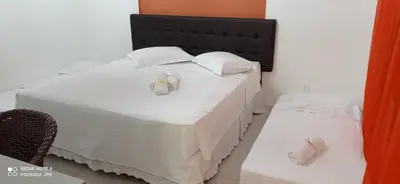 Uma cama ou camas num quarto em Pousada Jardim Porto Belo