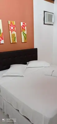 Uma cama ou camas num quarto em Pousada Jardim Porto Belo
