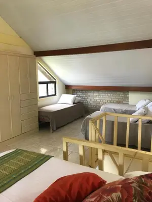 Uma cama ou camas num quarto em Pousada Beija-Flor