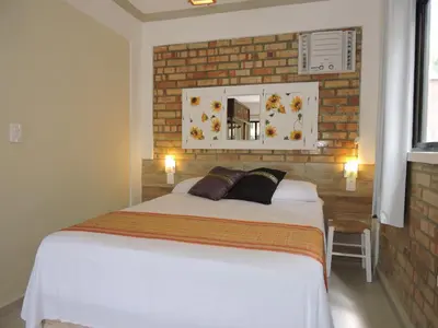 Uma cama ou camas num quarto em Pousada Beija-Flor