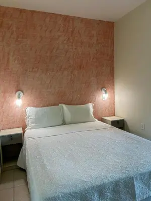 Uma cama ou camas num quarto em Pousada Cores do Mar | Conforto com Piscina em Bombinhas