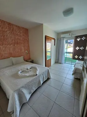 Uma cama ou camas num quarto em Pousada Cores do Mar | Conforto com Piscina em Bombinhas