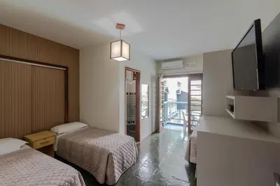 Uma cama ou camas num quarto em Pousada Cores do Mar | Conforto com Piscina em Bombinhas