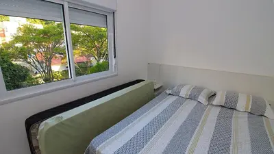 Uma cama ou camas num quarto em 1074 - Apartamento para locação no centro de Bombinhas