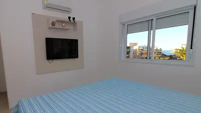 Uma cama ou camas num quarto em 1074 - Apartamento para locação no centro de Bombinhas