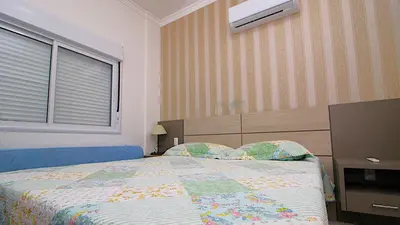 Uma cama ou camas num quarto em 1070 - Praia de Bombinhas locação de temporada.