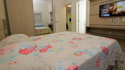 Uma cama ou camas num quarto em 1070 - Praia de Bombinhas locação de temporada.