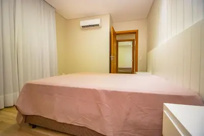 Uma cama ou camas num quarto em 1078 - Apartamento com vista para o mar em Bombinhas