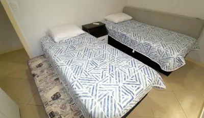 Uma cama ou camas num quarto em 1006 - Apartamento com vista para o mar