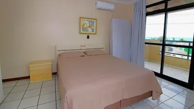 Uma cama ou camas num quarto em 1038 - Apartamento com vista para o mar Bombinhas