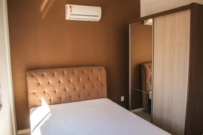 Uma cama ou camas num quarto em temporadabombinhas 2 suítes