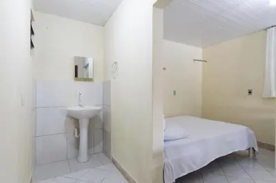 Uma cama ou camas num quarto em Pousada Dona Ema