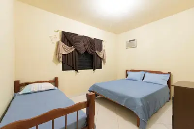 Uma cama ou camas num quarto em Pousada Dona Ema