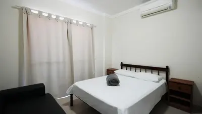 Uma cama ou camas num quarto em Edifício Costa Mar - Centro de Bombinhas