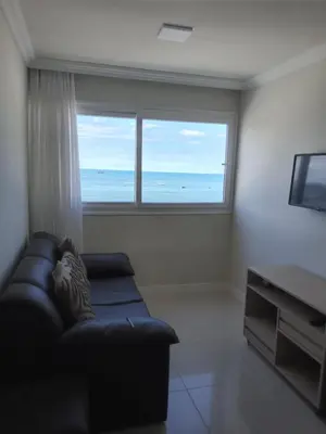 Uma área de estar em Apartamento frente ao mar