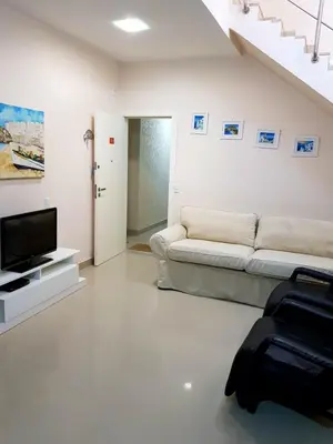 Uma televisão e/ou sistema de entretenimento em Cobertura Jacuzzi Vista Mar