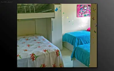 Uma cama ou camas num quarto em Cobertura Praia de Palmas