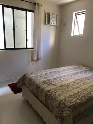 Uma cama ou camas num quarto em Apartamento na praia, quadra do mar, Rua novo píer