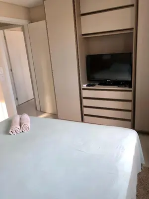 Uma cama ou camas num quarto em Camburiu Home 2004
