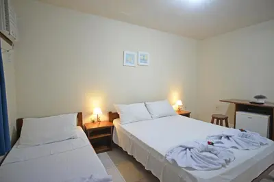 Uma cama ou camas num quarto em Oceano Pousada - Buffet de café da manhã e serviço de quarto diário