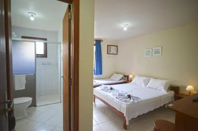 Uma cama ou camas num quarto em Oceano Pousada - Buffet de café da manhã e serviço de quarto diário