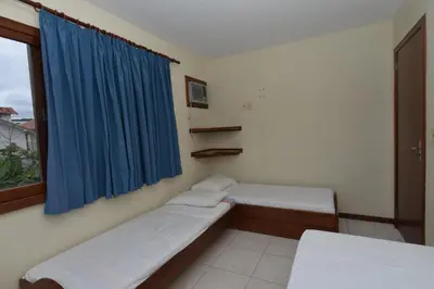 Uma cama ou camas num quarto em Oceano Pousada - Buffet de café da manhã e serviço de quarto diário
