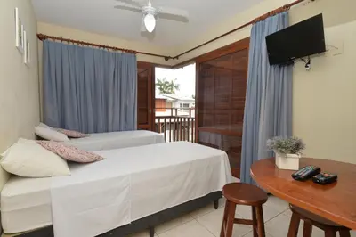 Uma cama ou camas num quarto em Oceano Pousada - Buffet de café da manhã e serviço de quarto diário