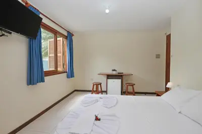 Uma cama ou camas num quarto em Oceano Pousada - Buffet de café da manhã e serviço de quarto diário
